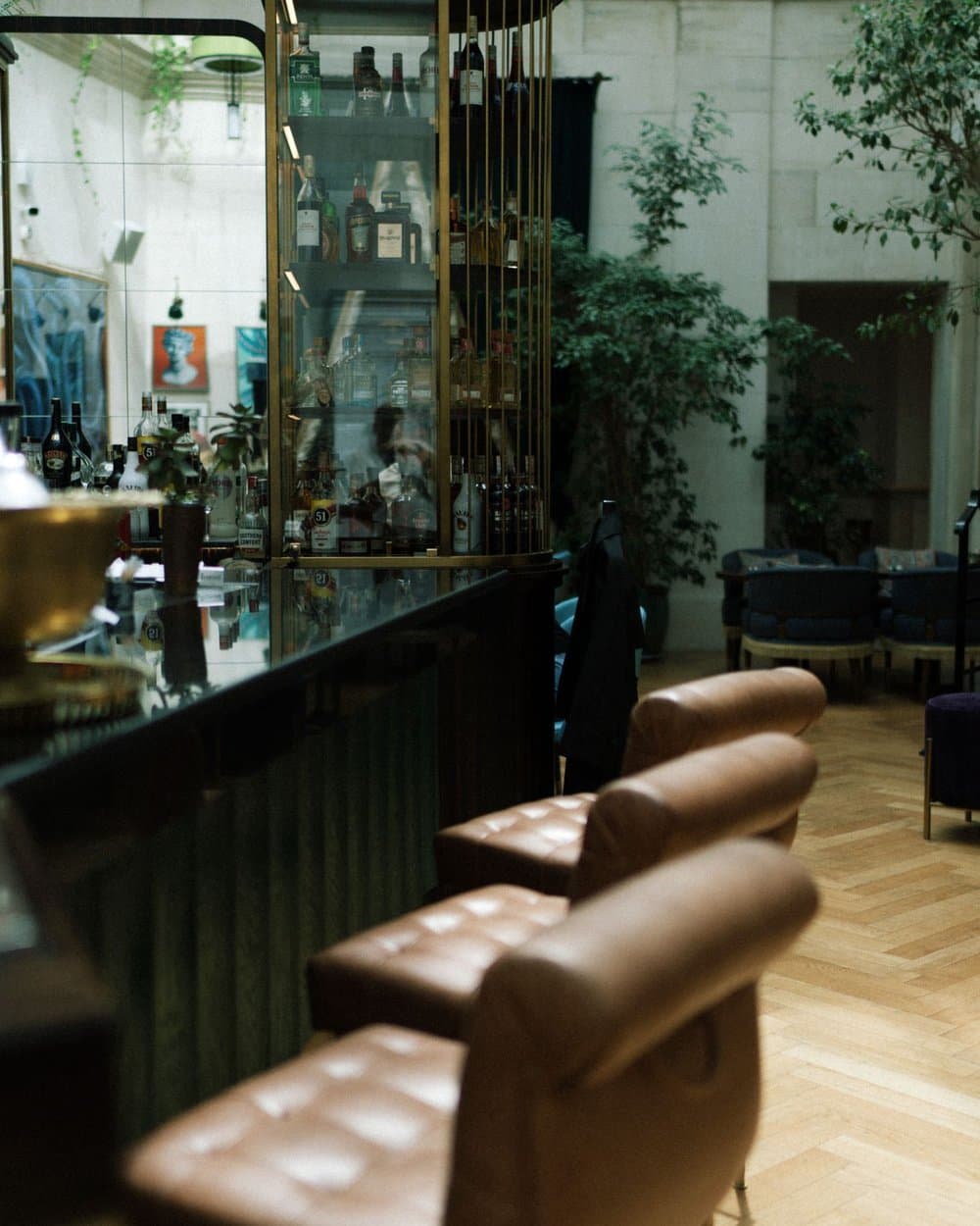 Hotel lounge with leather armchairs bathed in layered warm light