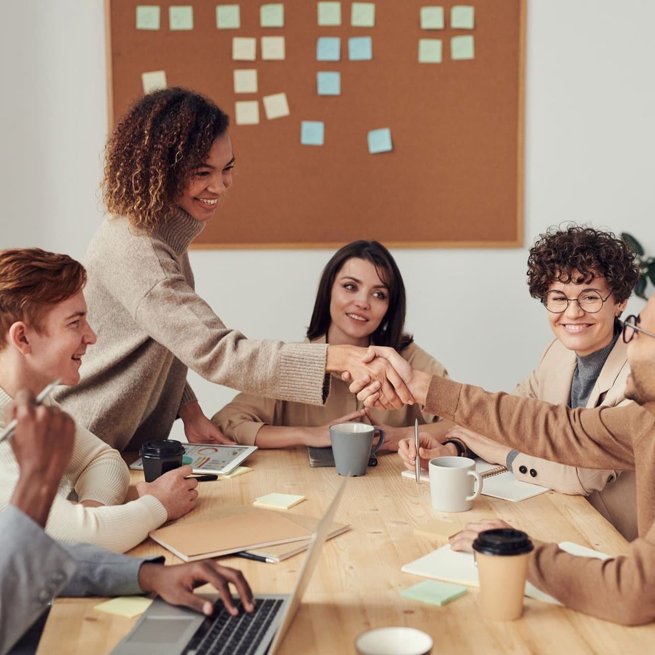 The FIDATO team collaborating warmly around a studio table