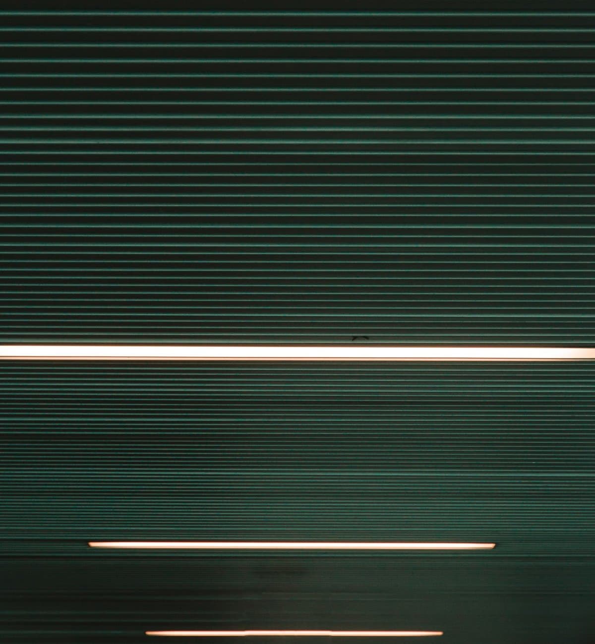Thin LED strip lines glowing across a dark ribbed surface