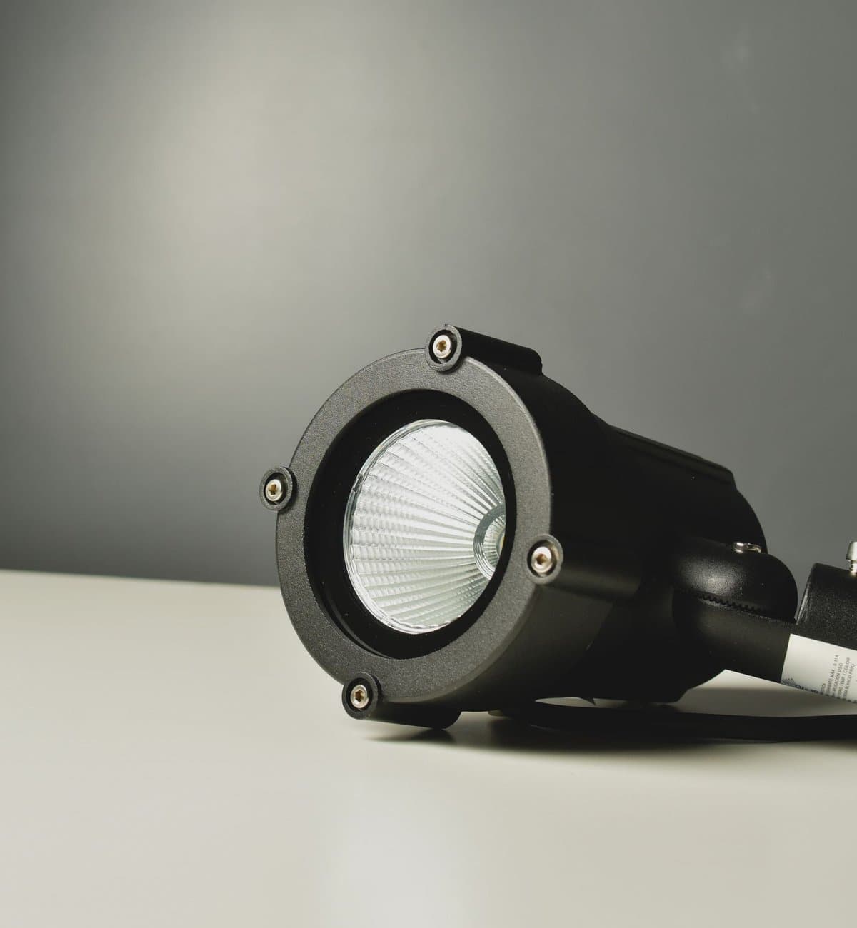 Close-up of a black COB LED spotlight fixture with a visible chip-on-board light source